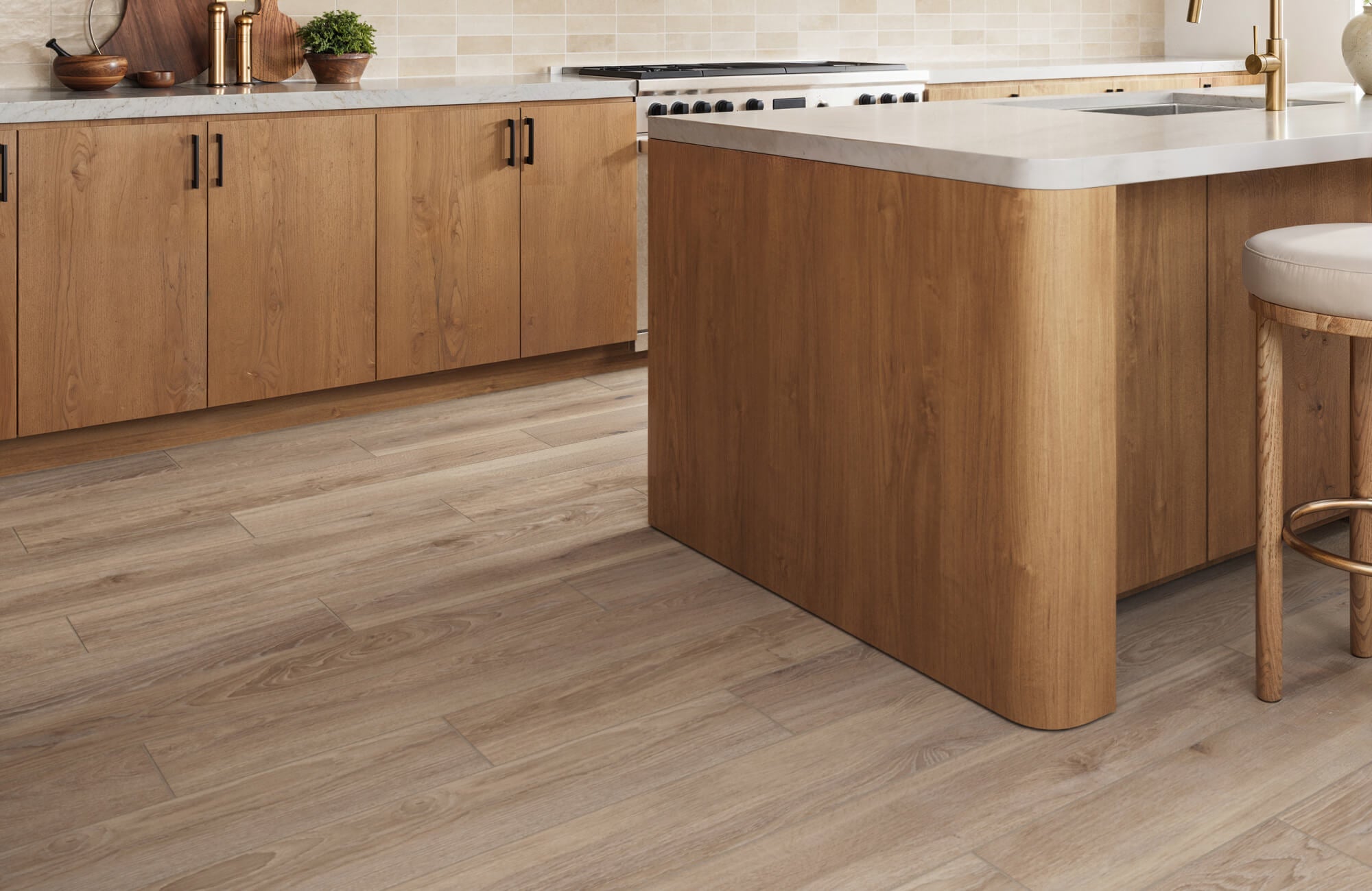 Warm wood-look tile flooring adds natural charm and continuity to this contemporary kitchen, complementing the wood cabinetry and clean, minimalist design.