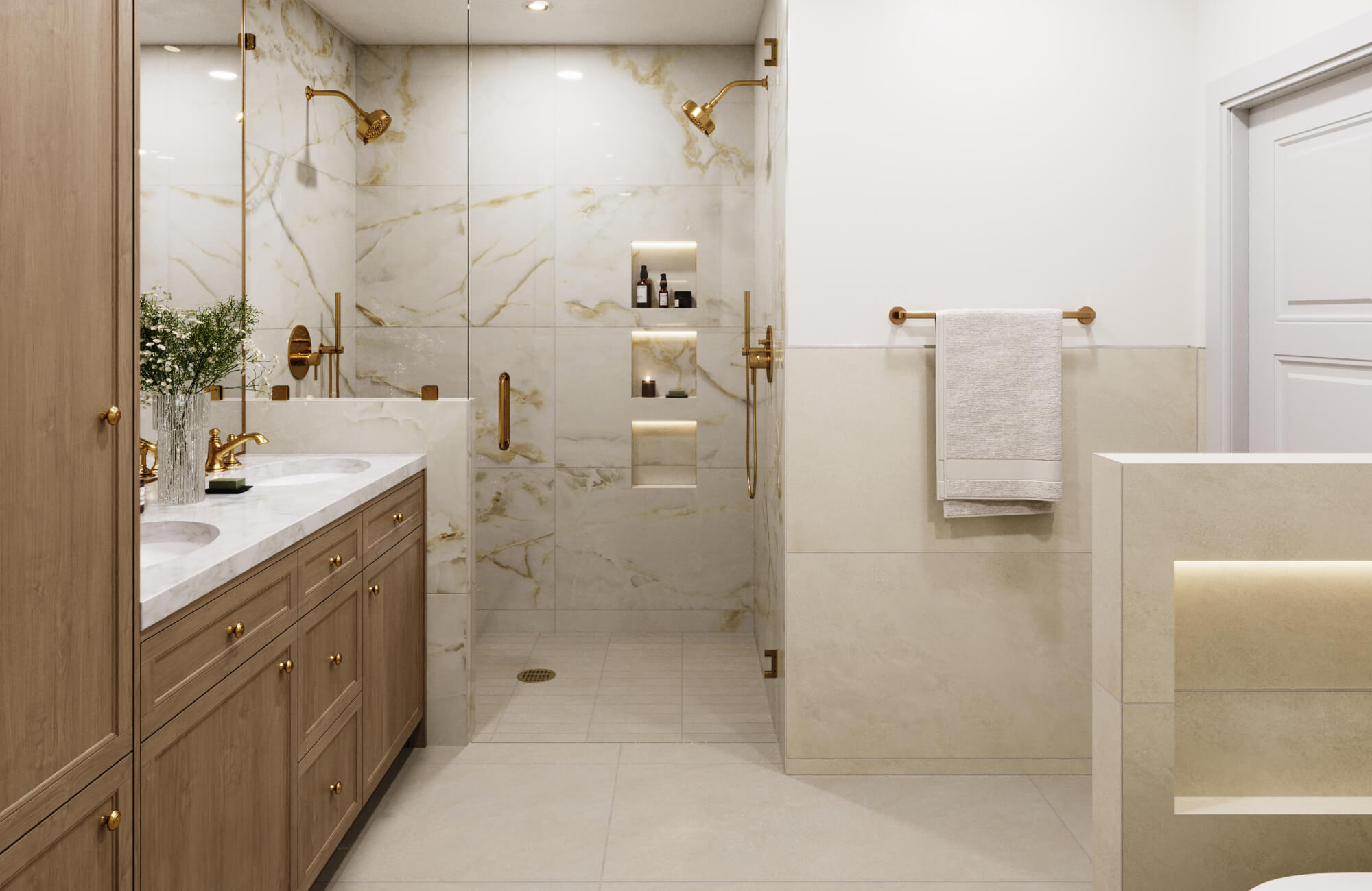 Luxurious bathroom with marble look shower walls, warm brass fixtures, and a double vanity with wood cabinetry, creating an elegant spa-like retreat.