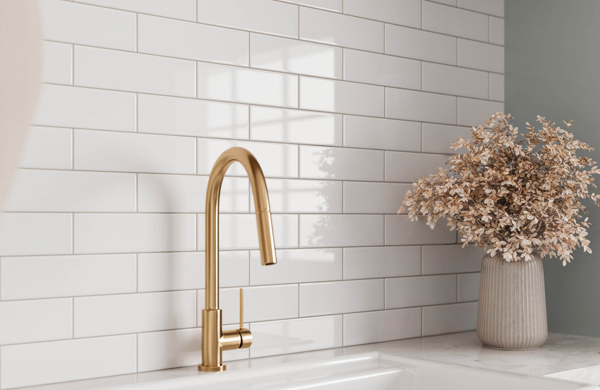 Clean and modern kitchen backsplash featuring glossy white subway tiles paired with a sleek gold faucet, adding a touch of elegance and warmth to the space.