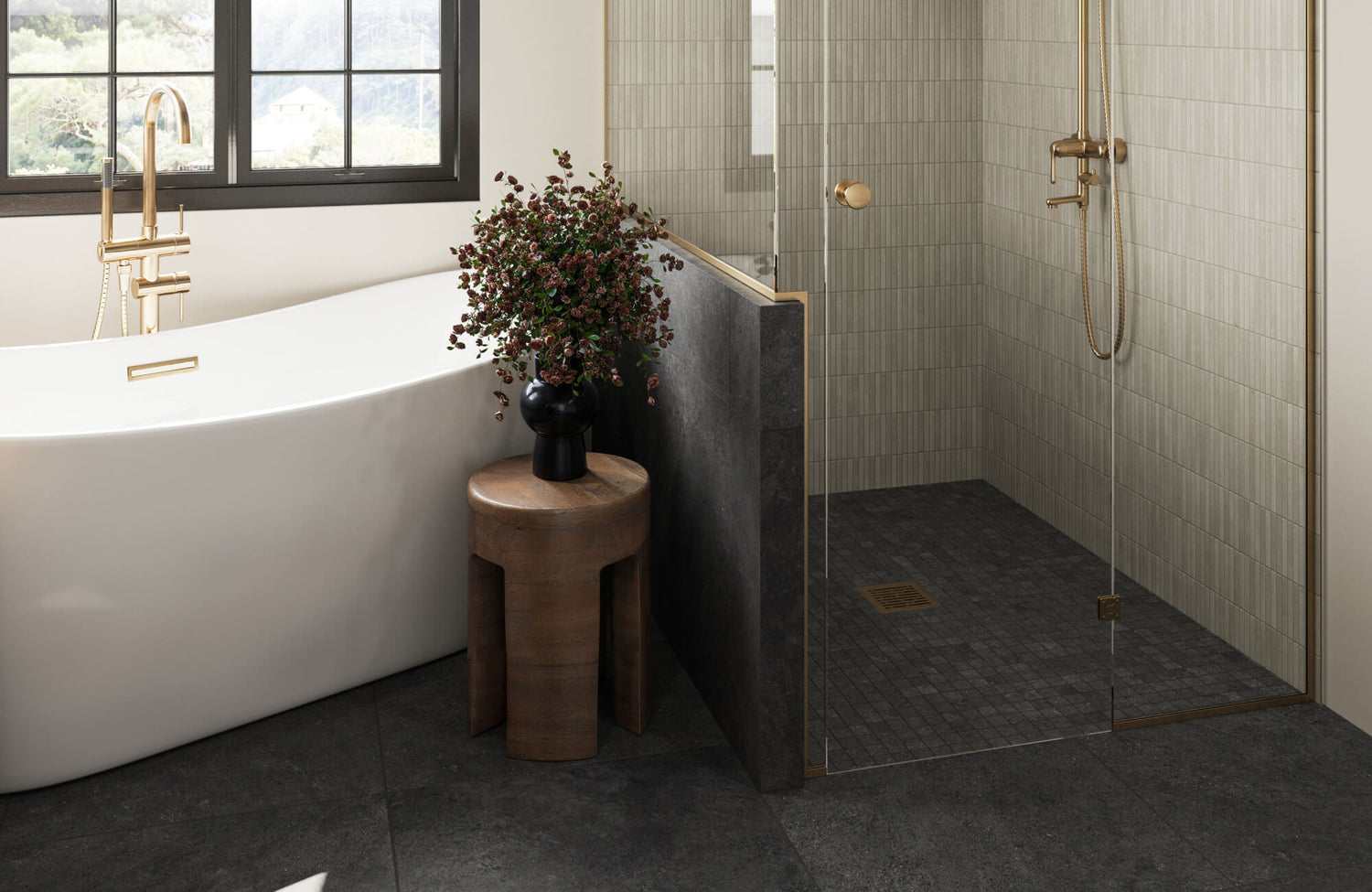 Elegant bathroom with a freestanding white tub, black porcelain floor tiles, and a walk-in shower featuring gold fixtures and sleek, vertical porcelain wall tiles.