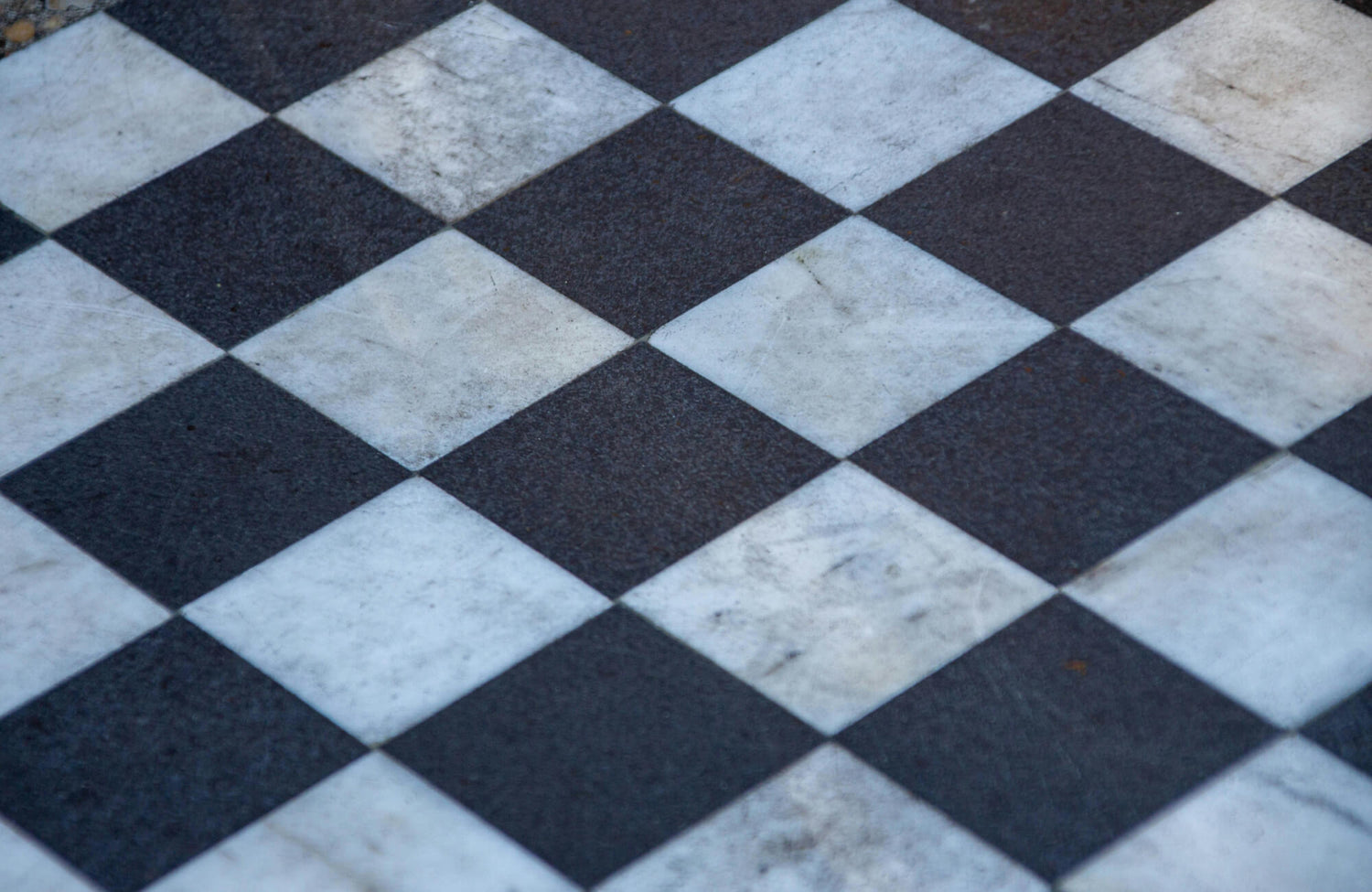 Close-up of a classic black and white checkered floor, highlighting its timeless elegance and versatility.