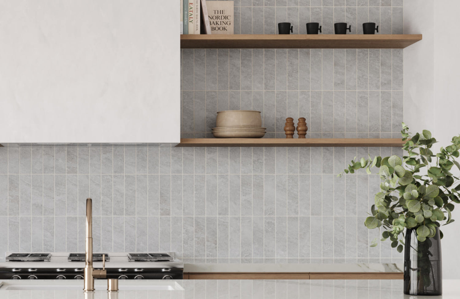 Close-up of a kitchen with light grey vertical subway tile backsplash, wooden open shelves displaying kitchen items, and a sleek faucet in front 