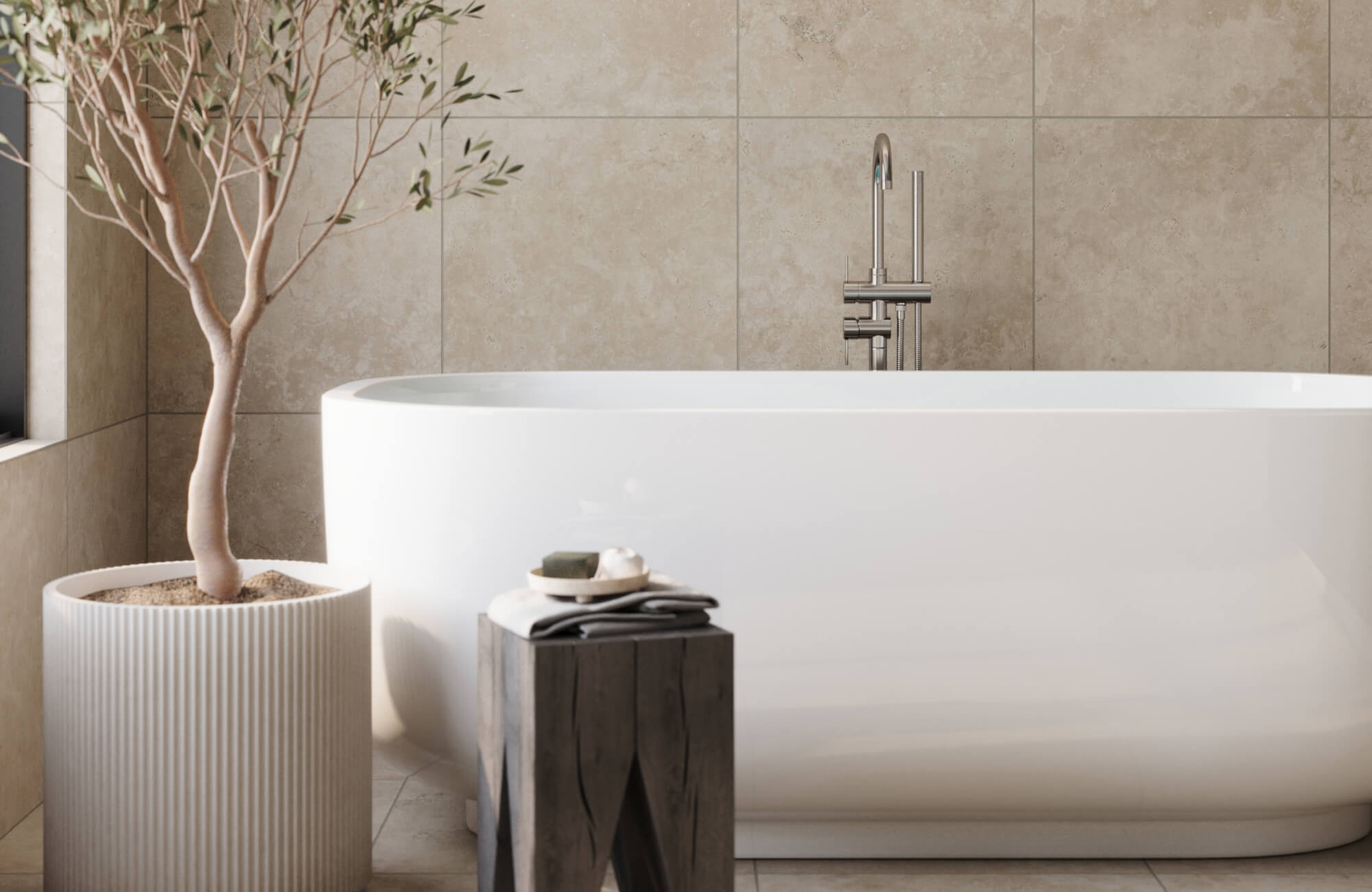 Minimalist bathroom featuring large beige tiles, a sleek freestanding tub, and an olive tree in textured planter, creating a serene, spa-like atmosphere.