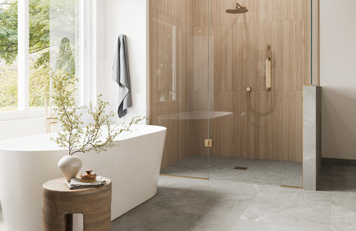 Modern bathroom featuring a freestanding tub, a glass-enclosed shower with wood-textured tiles, and gold fixtures, with serene outdoor views.