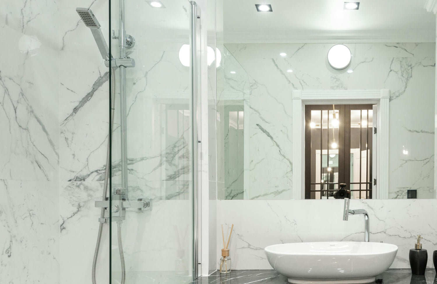 Luxurious bathroom featuring marble-look tiles with elegant veining, creating a serene and sophisticated ambiance.