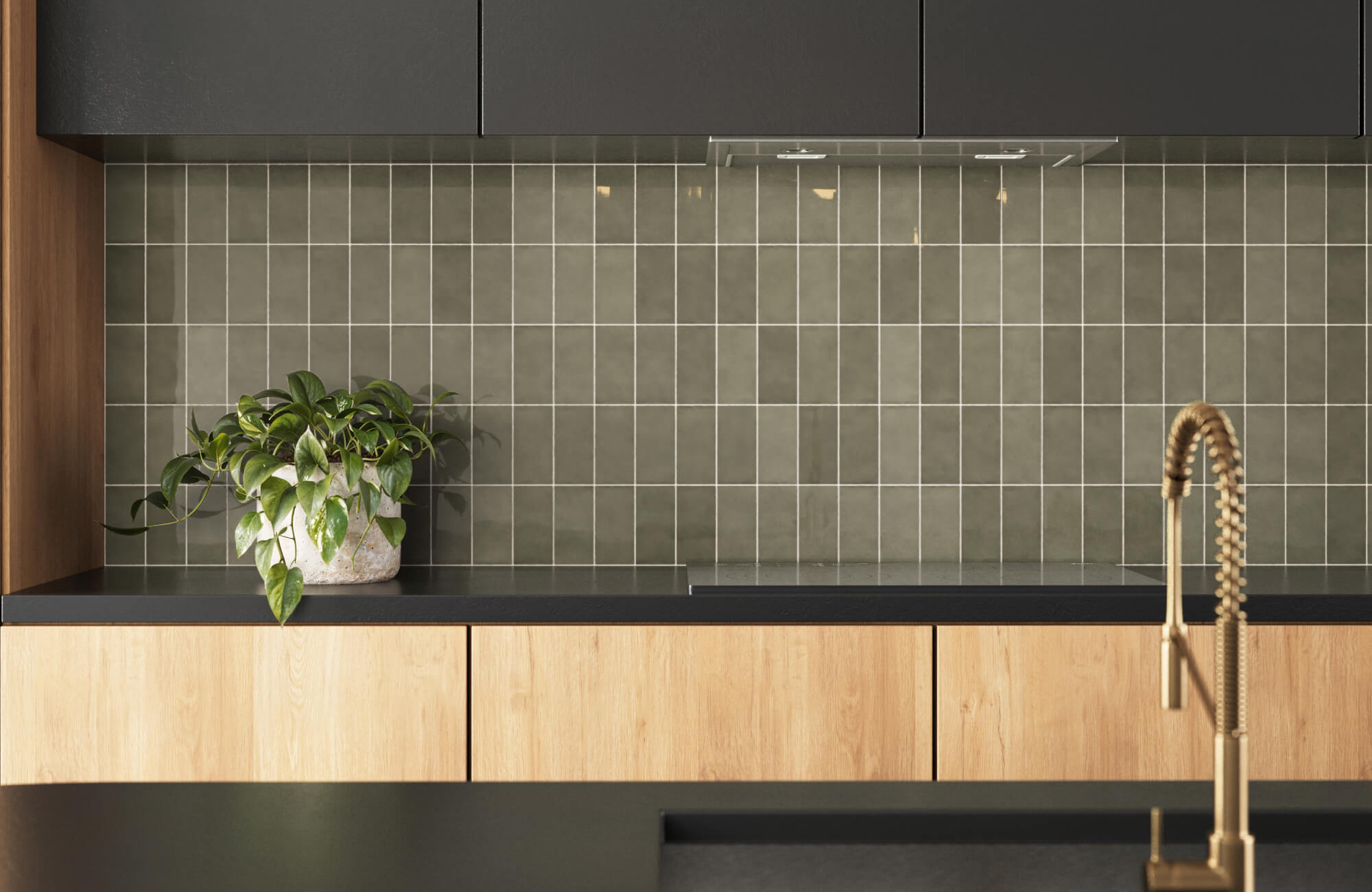 Olive green subway tiles create a sleek backsplash, accented by wooden cabinets and a potted plant for a modern look.