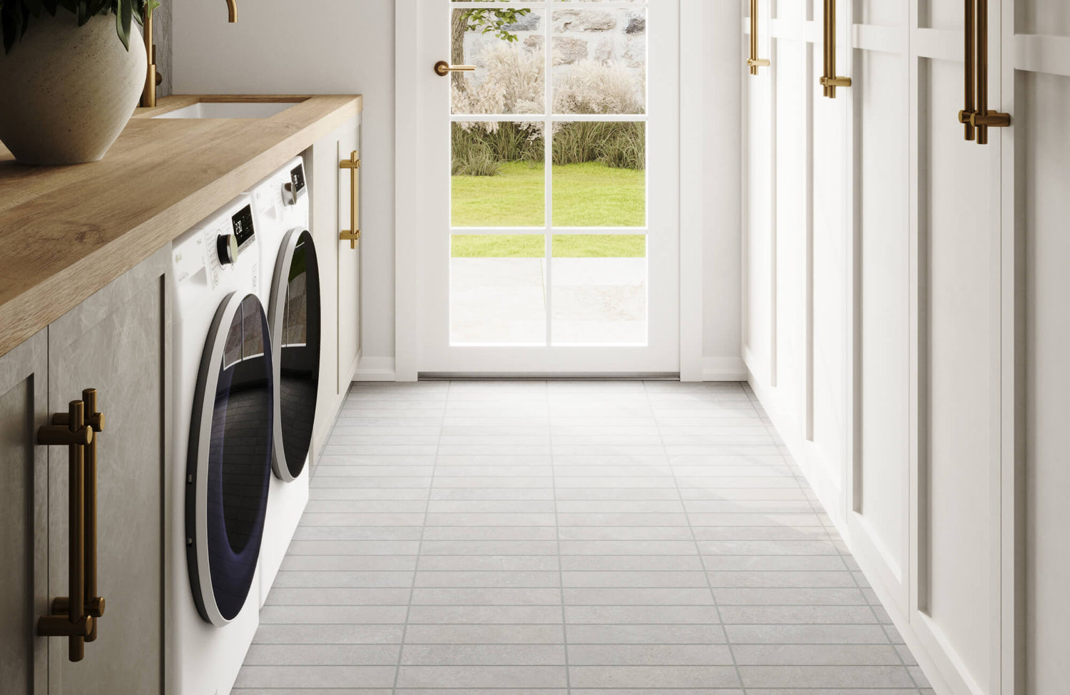 Bright laundry room featuring light grey subway tiles, sleek white appliances, and gold hardware, creating a clean and stylish workspace.