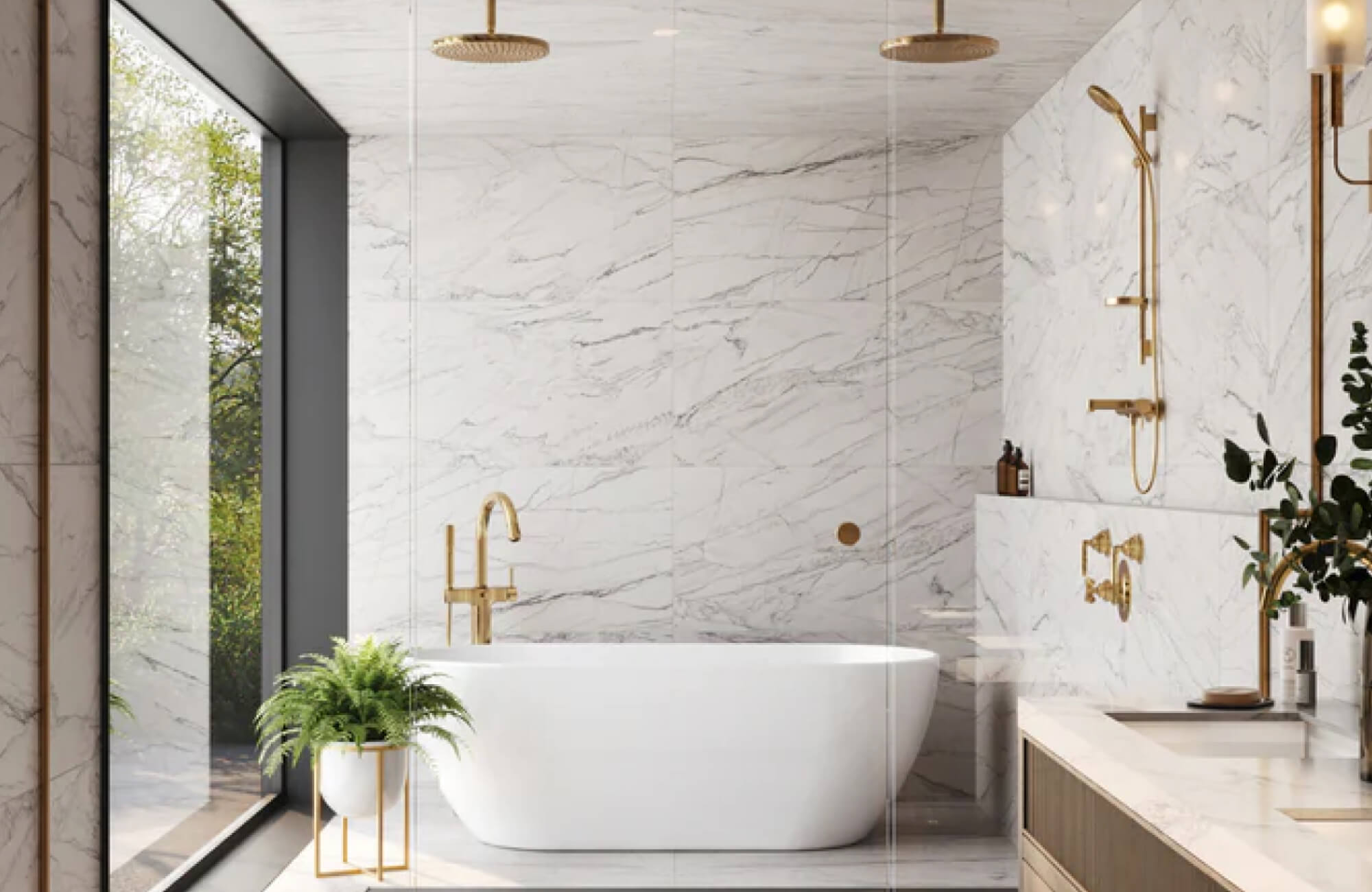 Luxurious bathroom featuring white marble-look tiles, a freestanding tub, gold fixtures, and a large window framing lush greenery