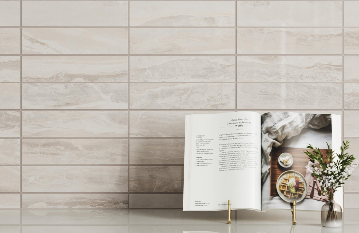 Elegant taupe marble subway tiles with cookbook and florals