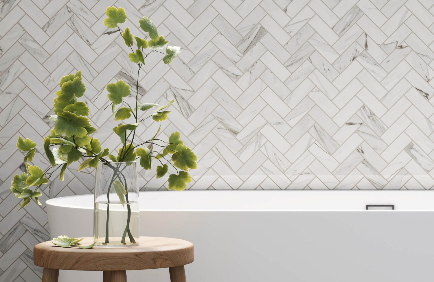 Elegant bathroom featuring herringbone-patterned subway tiles with green foliage accent