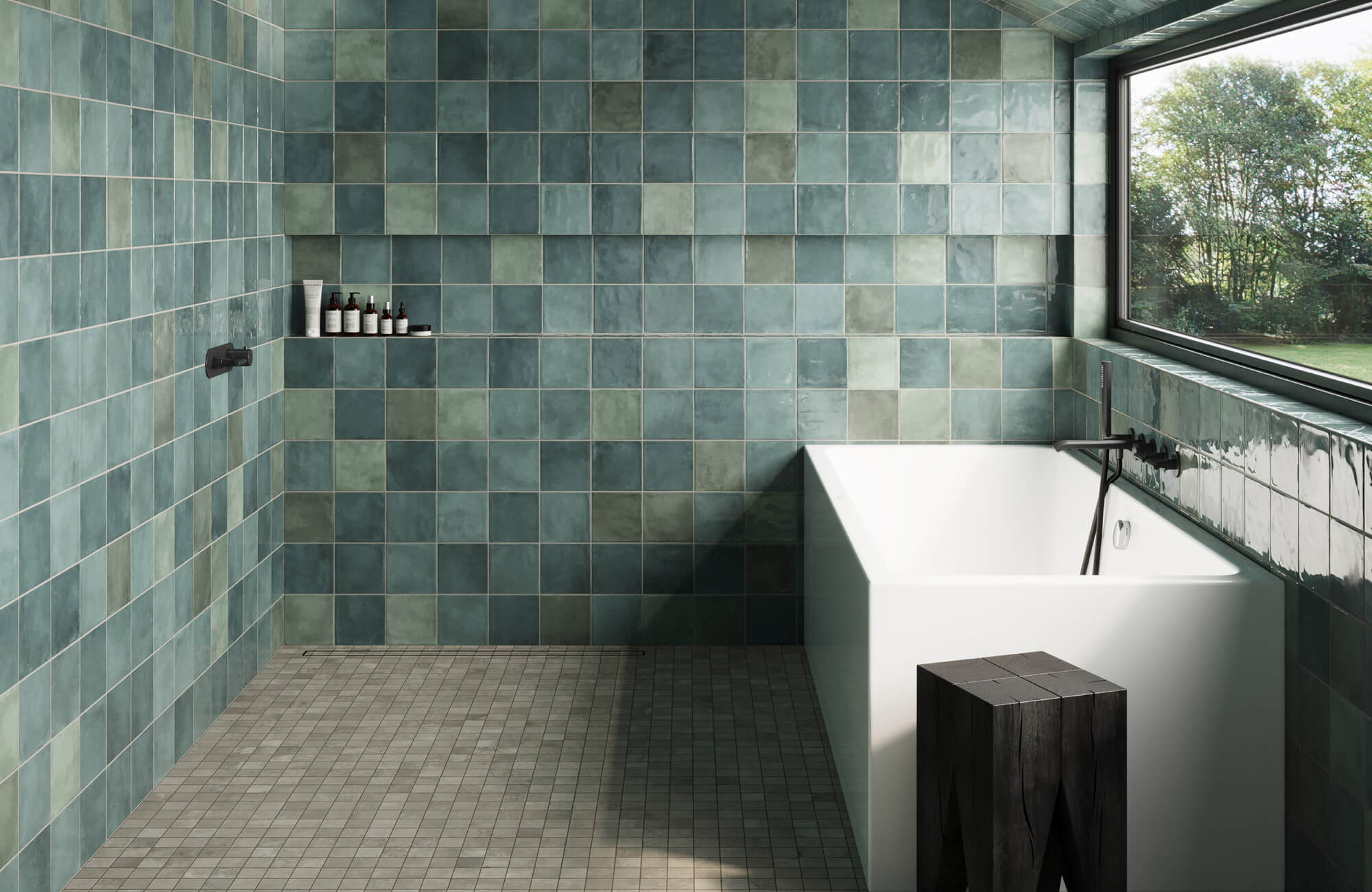 Minimalist bathroom featuring green square tiles with a matte finish, a freestanding white tub, and large windows, creating a tranquil, spa-like atmosphere.