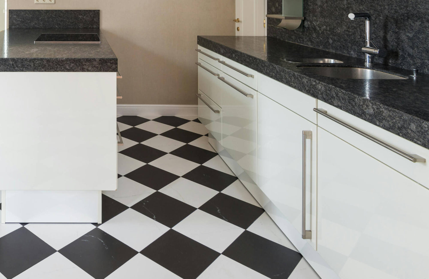 Product photo of black and white checkerboard tiles arranged in a square pattern, offering a bold and dynamic design for kitchen floors or backsplashes.