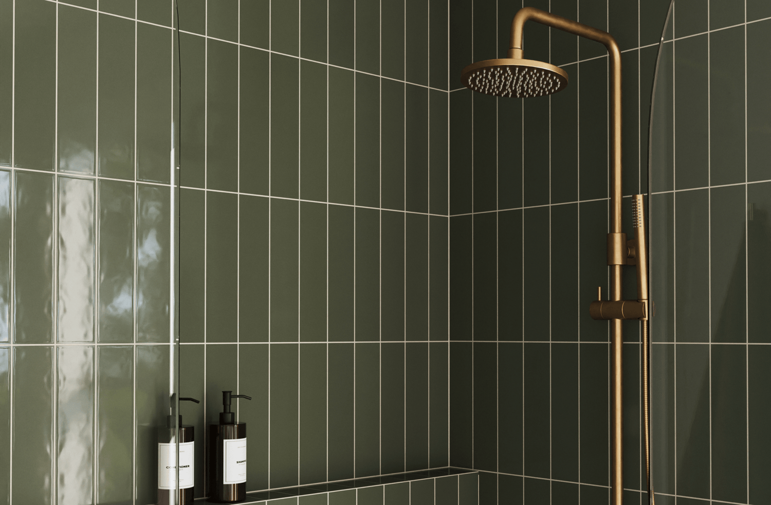 Elegant shower with deep green subway tiles and a sleek brass rain showerhead, creating a modern, luxurious bathroom look.