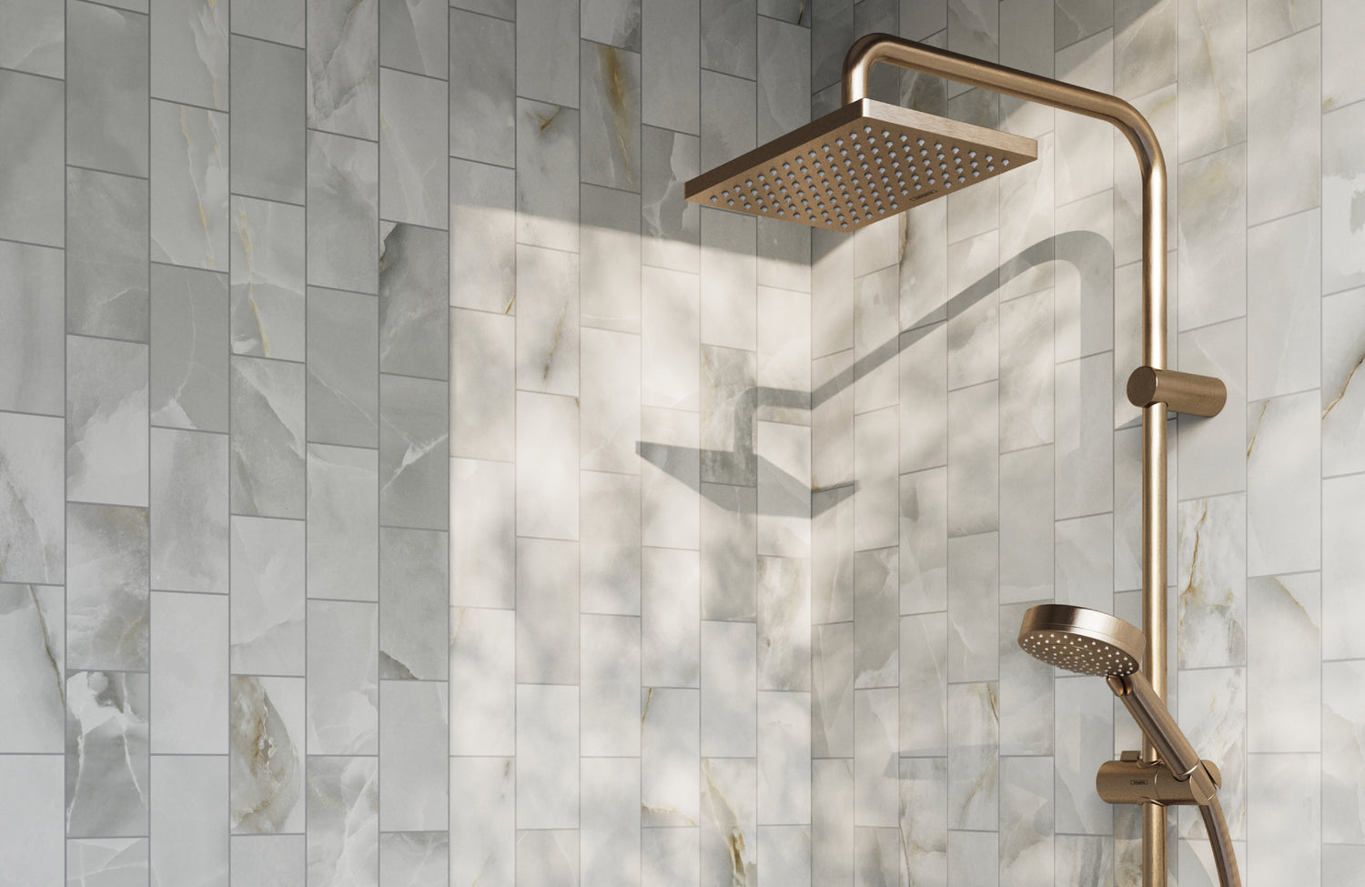 Luxurious shower with marble-look subway tiles, complemented by a sleek brass showerhead and handle. 