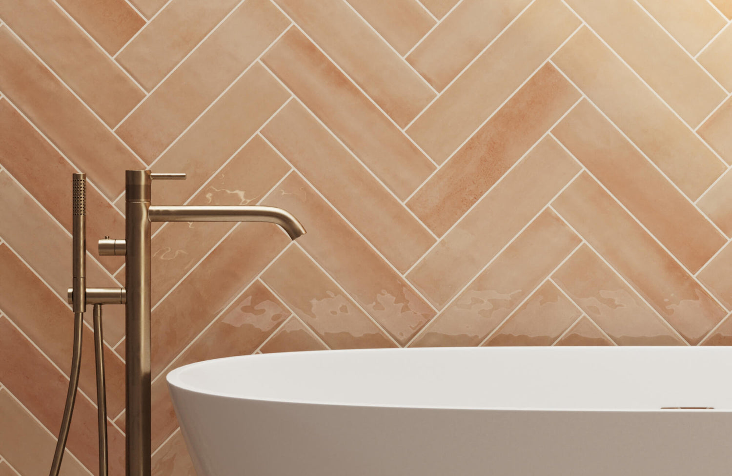 Herringbone patterned subway tiles in warm terracotta tones complemented by sleek fixtures