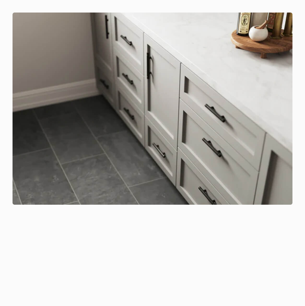 Dark grey kitchen floor tiles paired with white cabinetry, offering a stylish and modern contrast for a sophisticated kitchen design