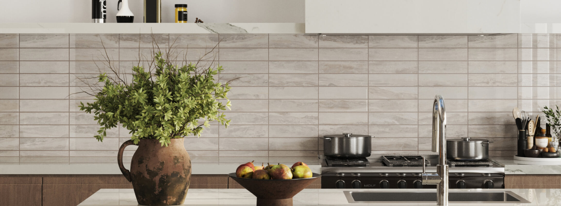 Modern kitchen with taupe marble-effect subway backsplash tiles, a polished marble countertop, and natural accents including a rustic vase of greenery