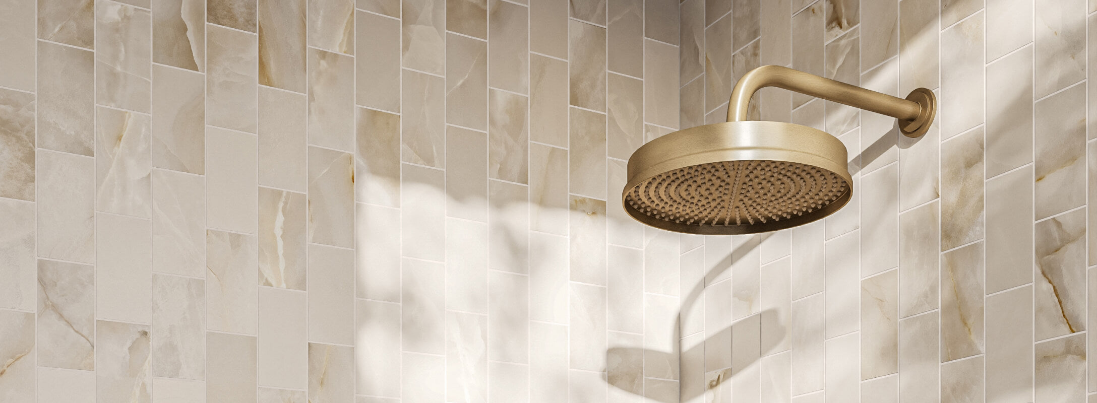 Chic beige marble-effect mosaic tiles enhance the shower wall, catching light and creating a warm, luxurious atmosphere