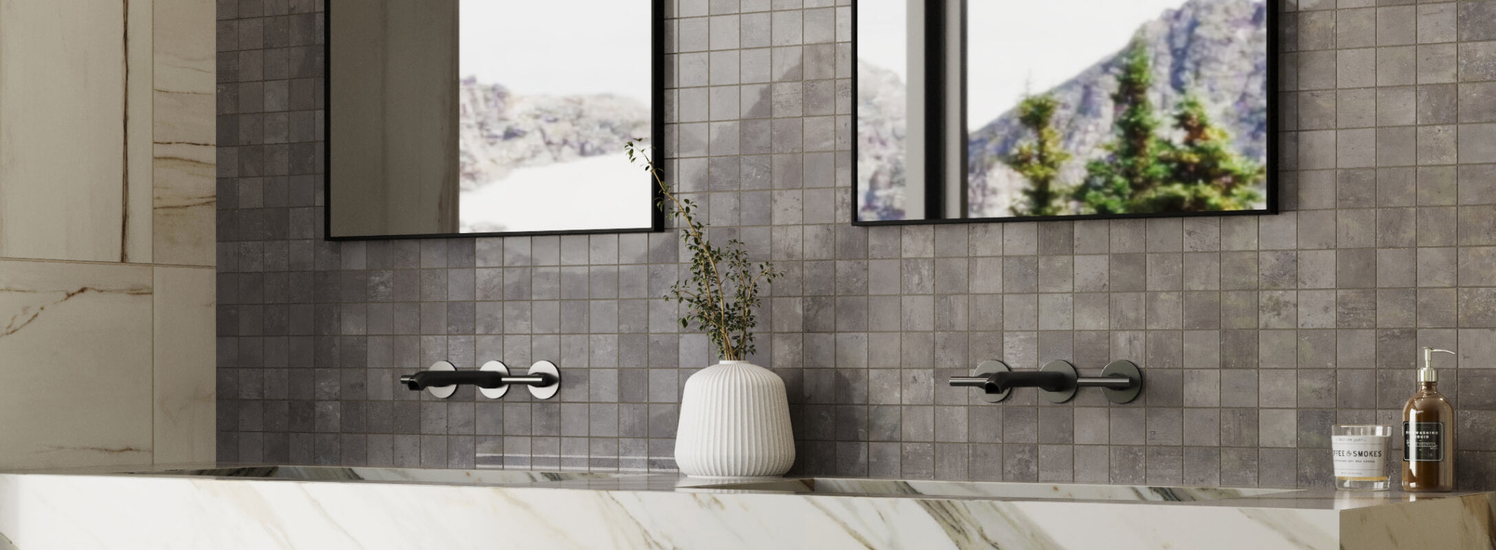 Chic bathroom features a vanity mirror framed by dark grey cube mosaic tiles, adding a modern touch with a marble countertop and elegant accessories