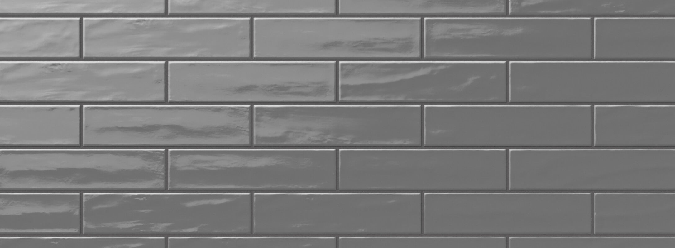 Glossy dark grey ceramic tiles in a classic subway layout, adding a sleek and modern touch to bathroom walls