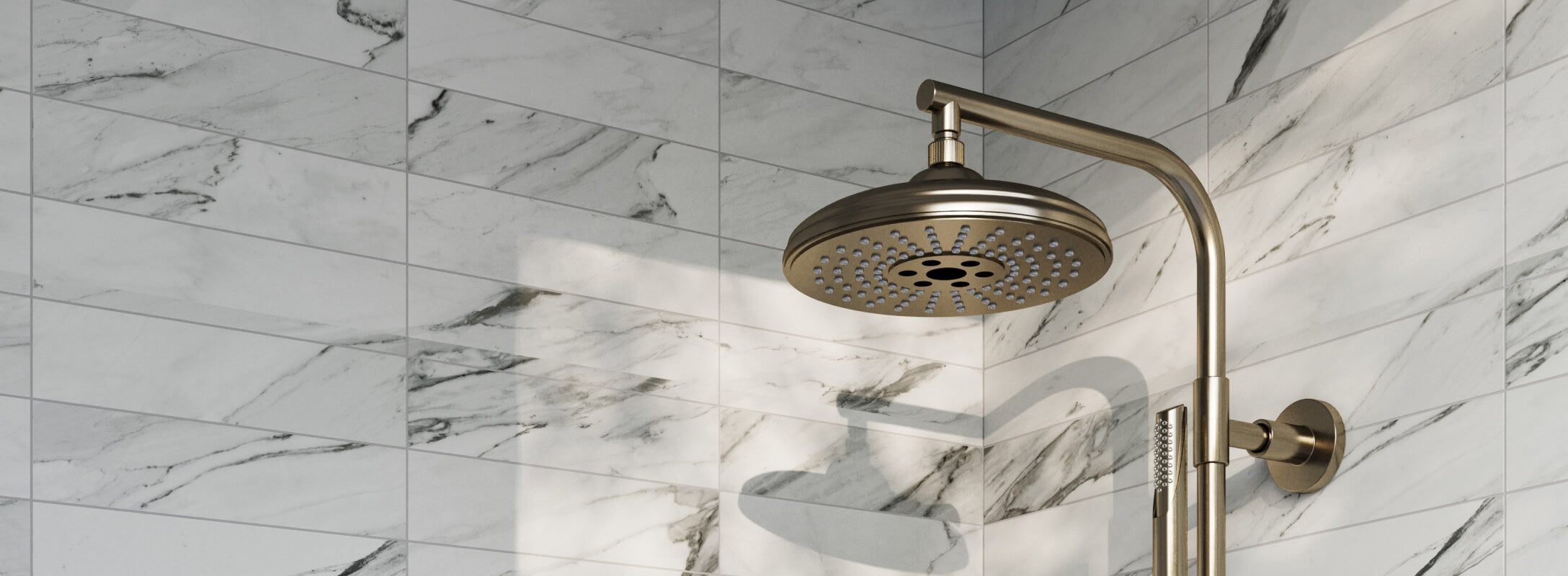 Elegant shower with light grey marble look tiles and a brass rainfall showerhead, creating a luxurious and timeless look