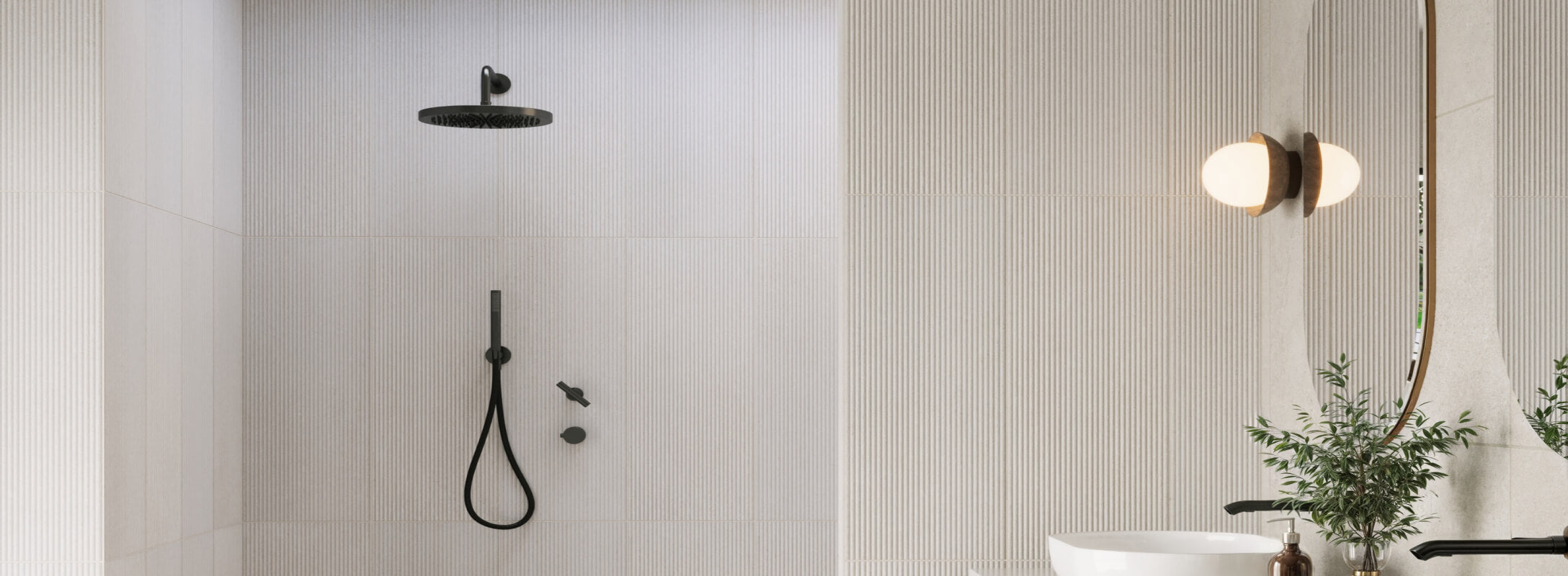 Modern bathroom featuring vertical white textured tiles, a sleek black shower head, and a globe wall light