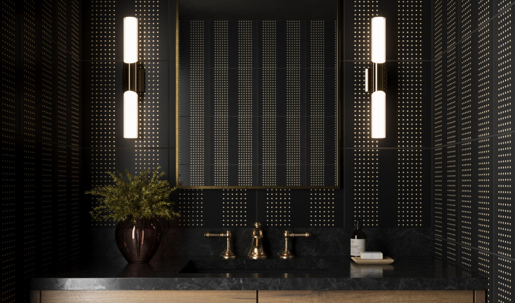 Stylish bathroom with black perforated tiles featuring a metallic finish, brass fixtures, and a dark marble countertop, illuminated by modern vertical lights