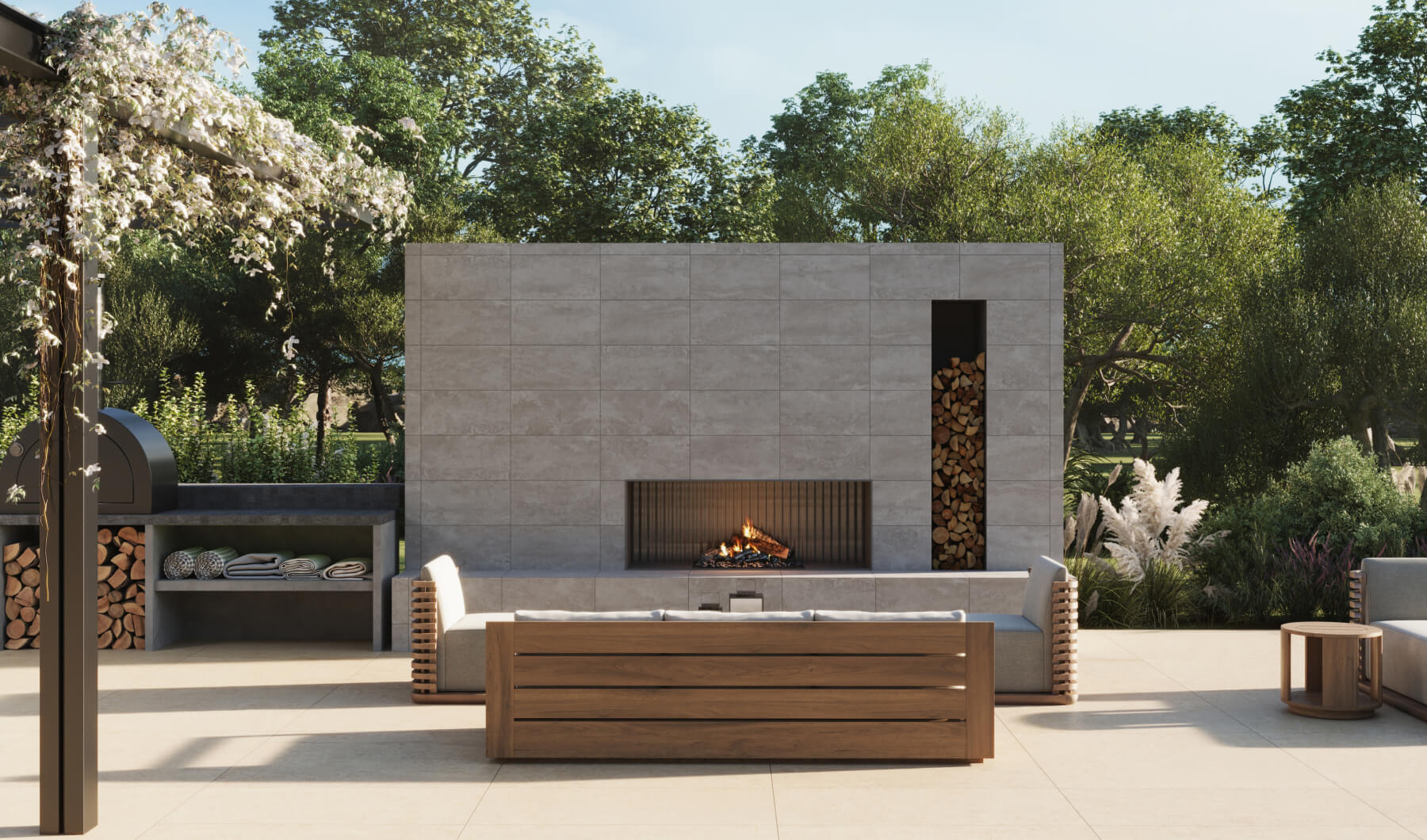 Spacious outdoor patio featuring taupe stone-look tiles, a modern fireplace, comfortable seating, and lush greenery