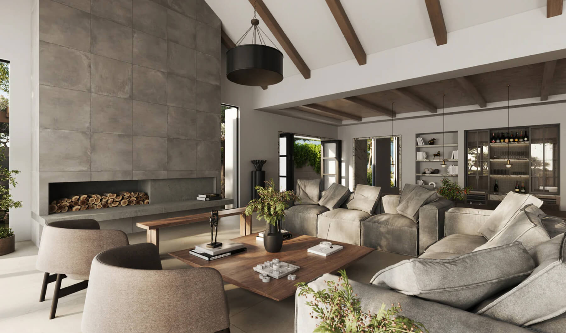 Spacious living room with a modern design, featuring a large fireplace wall with concrete-look tiles, exposed wooden beams, and plush seating