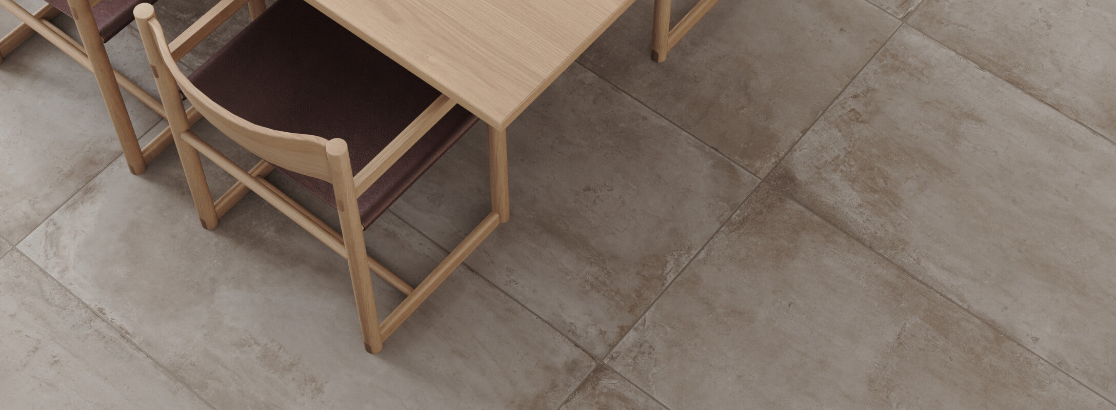 Modern dining room featuring concrete look porcelain tile flooring, offering a minimalist, urban vibe with sleek sophistication