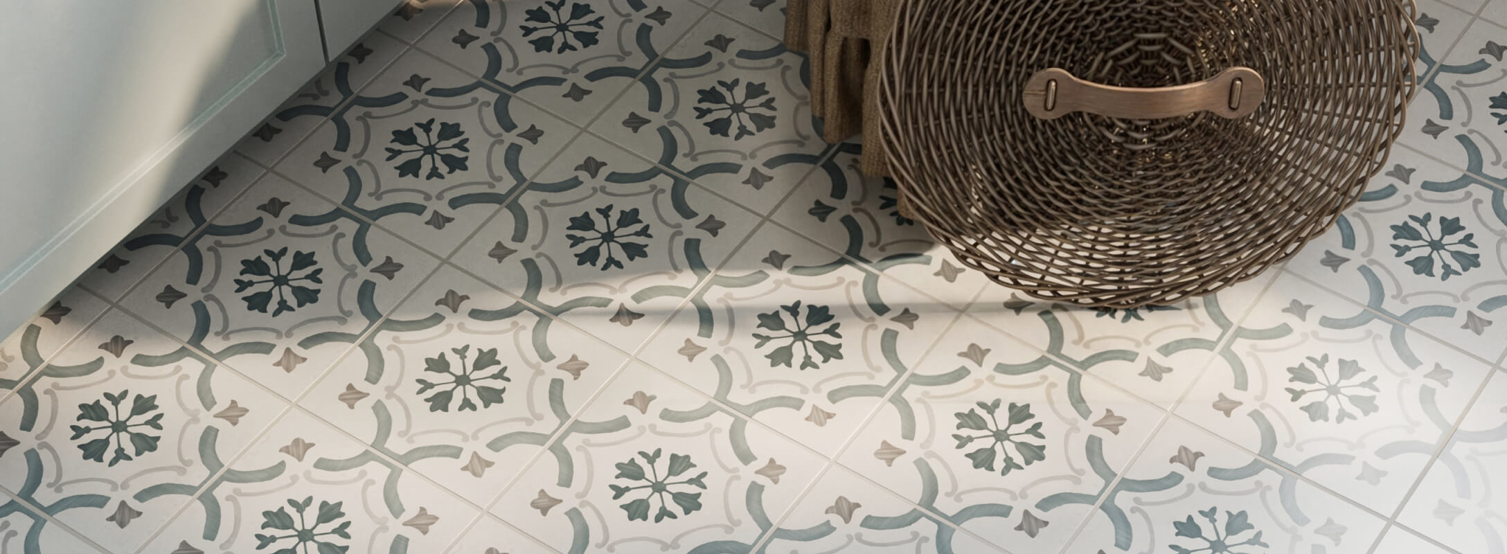 Ornate floor tiles with intricate blue, white, and gray floral-like patterns create a classic, decorative look, complemented by a woven basket