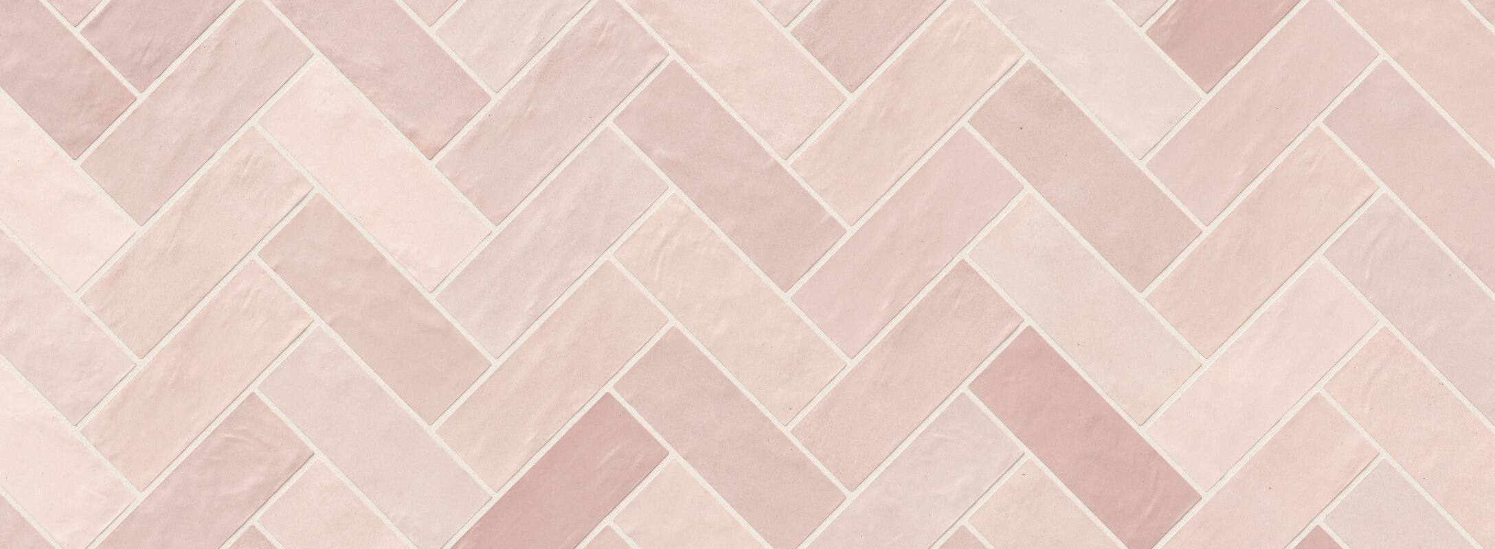 Red herringbone tiles in light shades with a subtle texture, perfect for adding a soft, elegant touch to kitchen walls