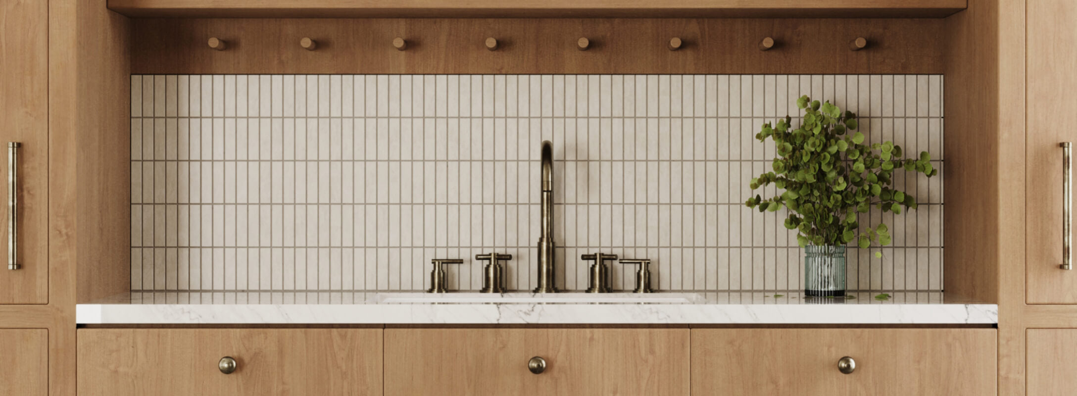 Modern kitchen with vertical subway mosaic stone look tiles, natural wood cabinets, and a sleek stainless steel faucet, enhanced by a lush green plant