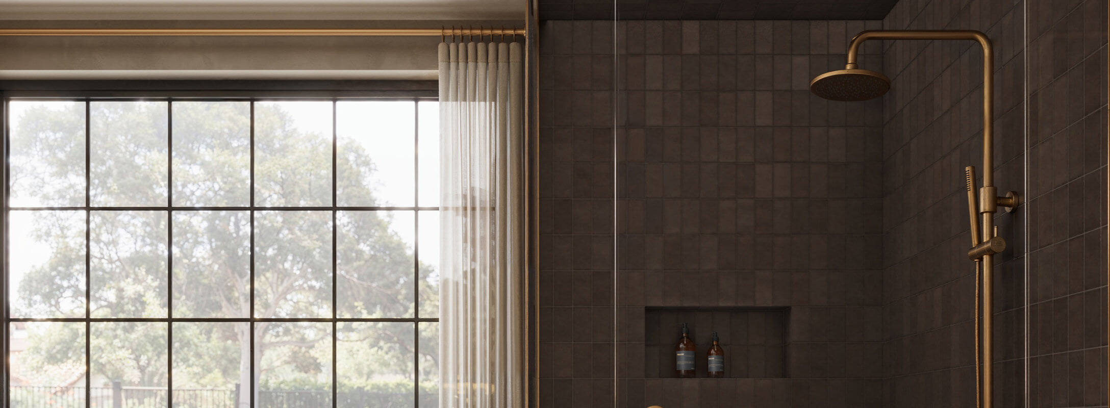 Luxurious bathroom featuring rich brown subway tiles, a brass shower fixture, and a large window with sheer curtains