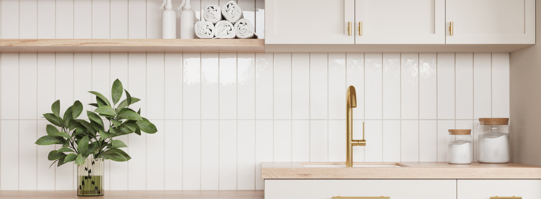 Elegant kitchen backsplash featuring glossy white subway tiles, complemented by a gold faucet and natural wood accents