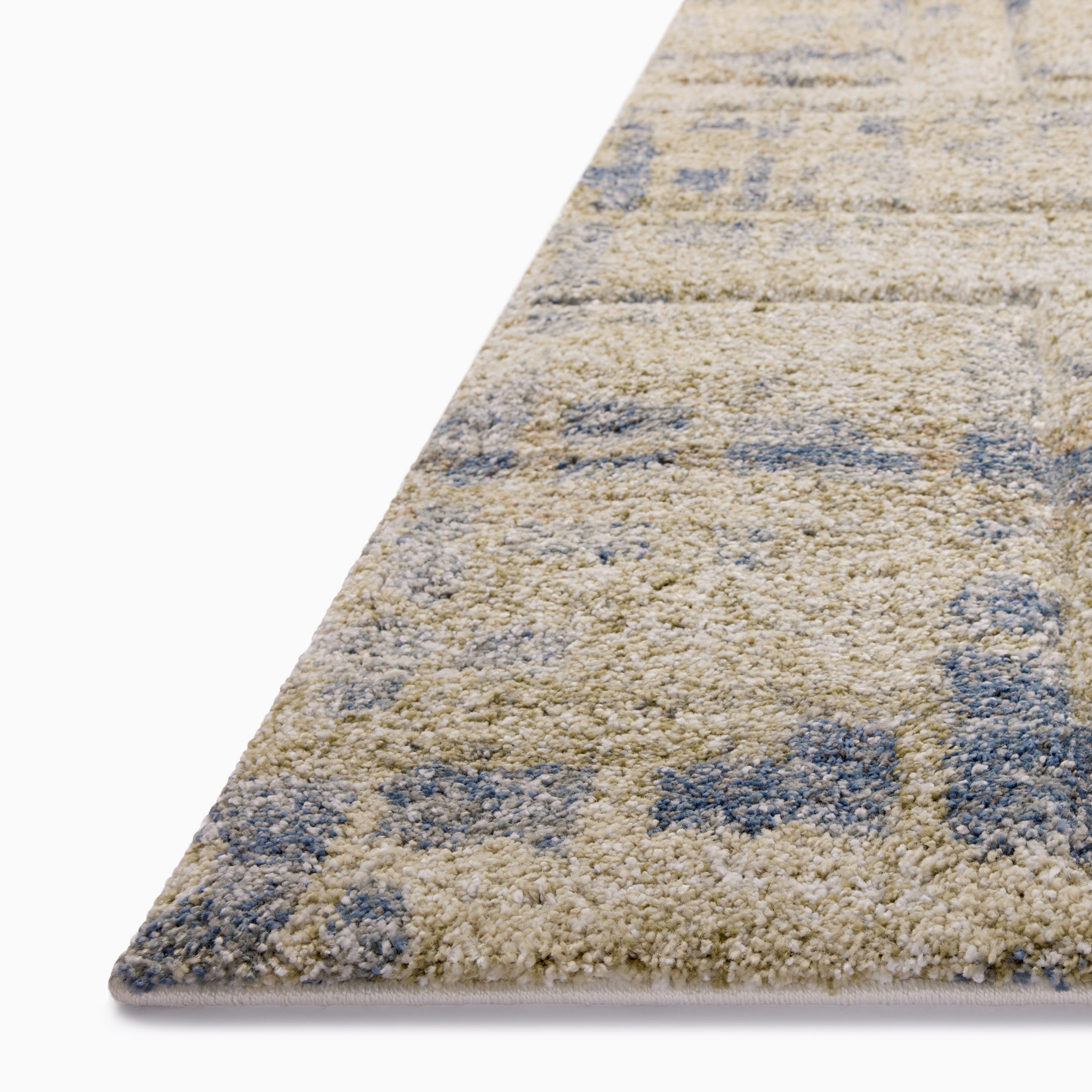 Close-up of a plush beige and blue area rug with a textured abstract design, highlighting its soft and detailed weave.