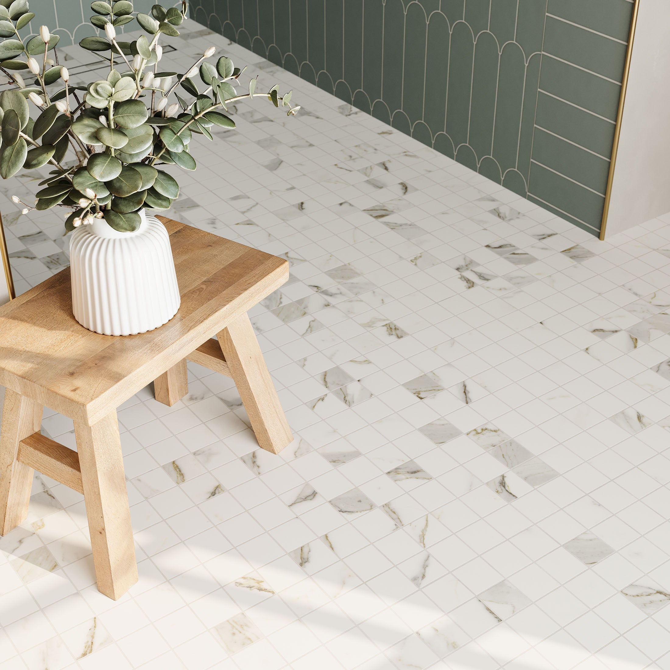 Close-up of marble look mosaic flooring with light grey and gold veining, paired with a natural wood bench and a white ceramic vase for a modern, elegant aesthetic.