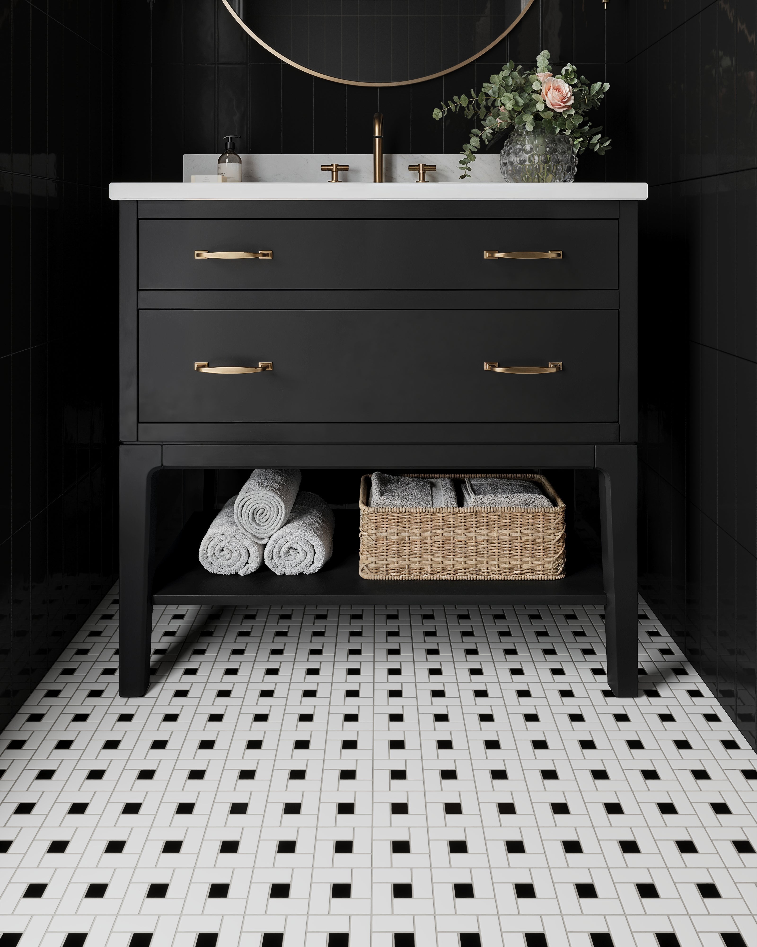 Sophisticated bathroom with glossy black walls, a matte black and white white pinwheel mosaic floor, and a sleek black vanity accented by gold fixtures.