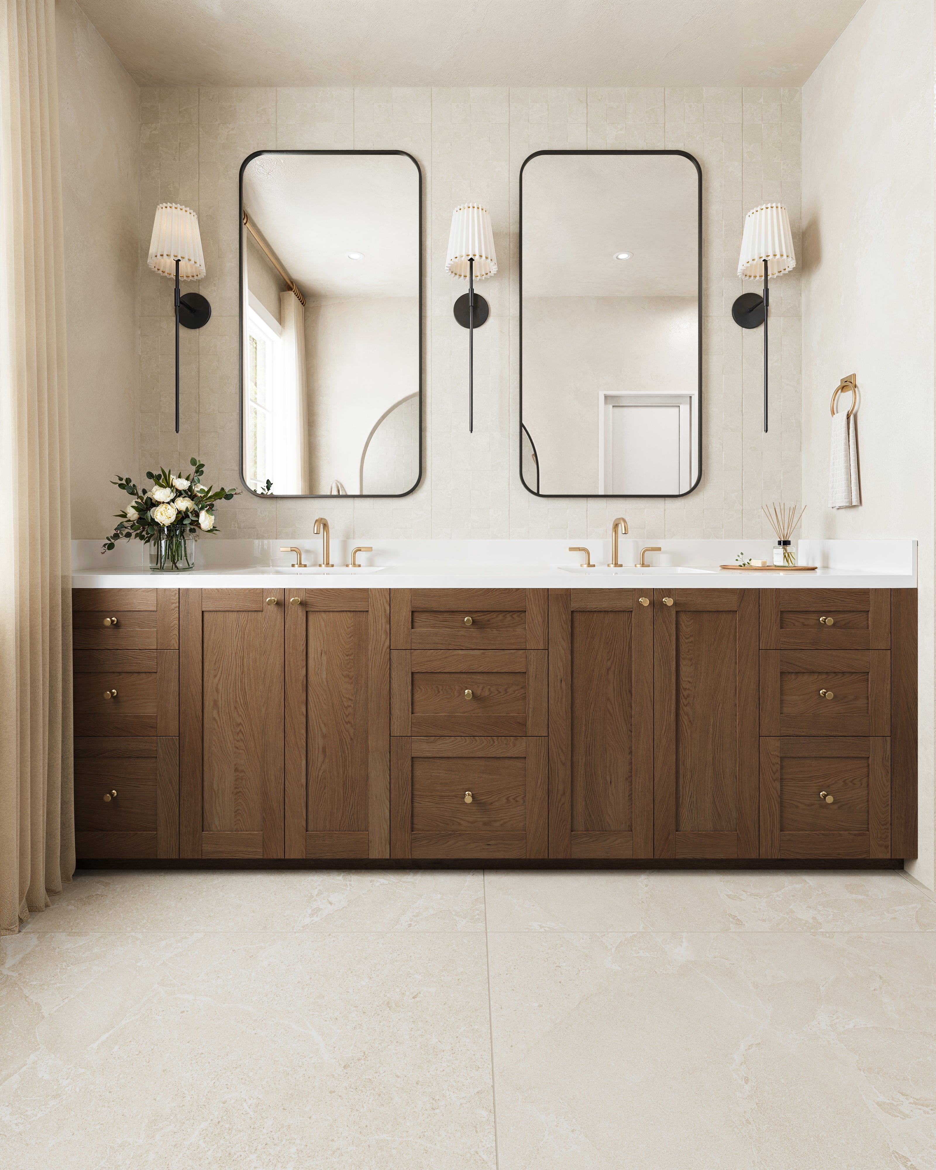 Sophisticated bathroom design featuring a double vanity with rich wooden cabinetry, brass fixtures, and soft beige floor tiles.