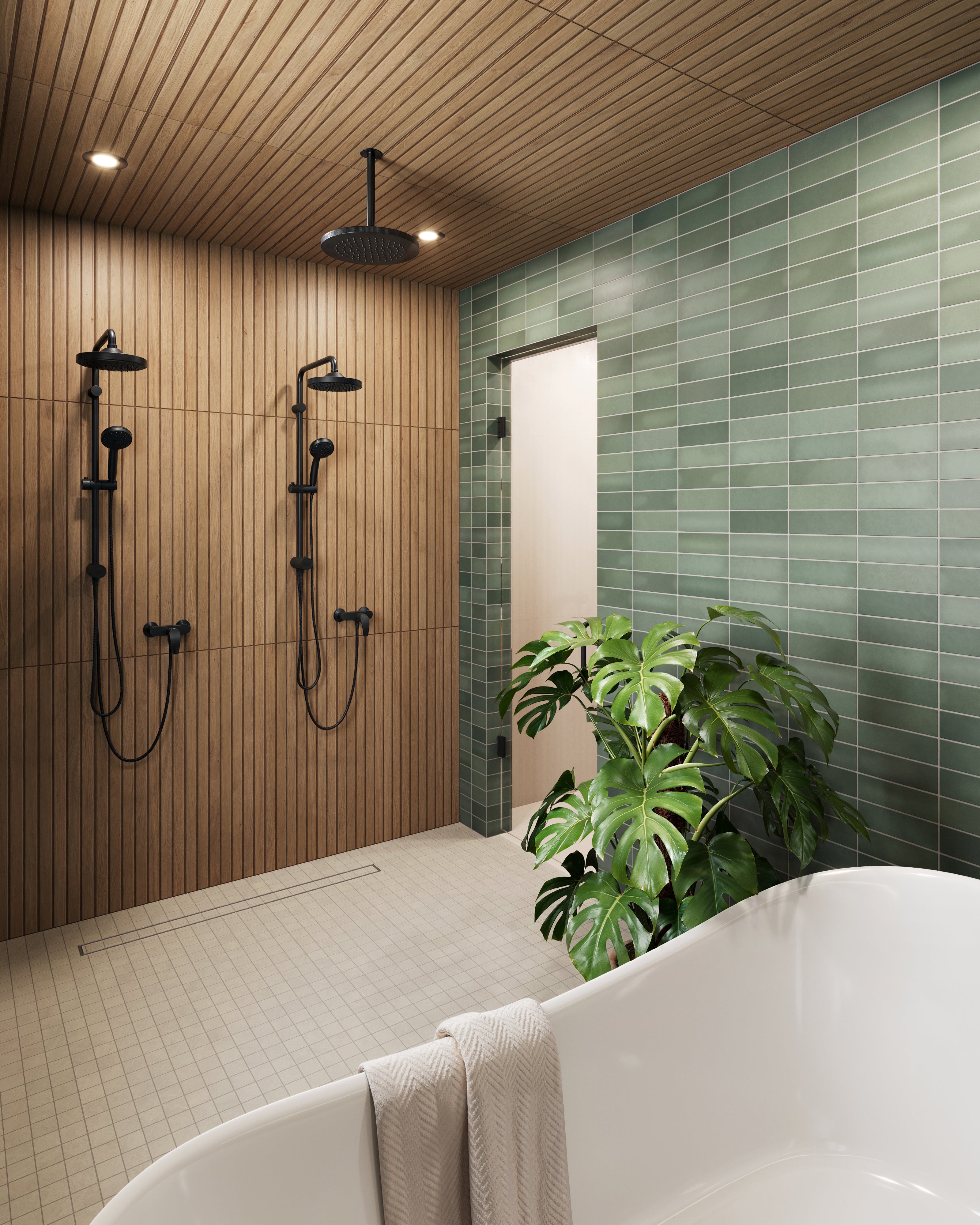 Spa-like bathroom featuring matte green subway tiles, Zayne 12x36 matte ceramic tile in a brown ribbed wood slat, dual black showerheads, and a freestanding bathtub with a tropical plant accent.