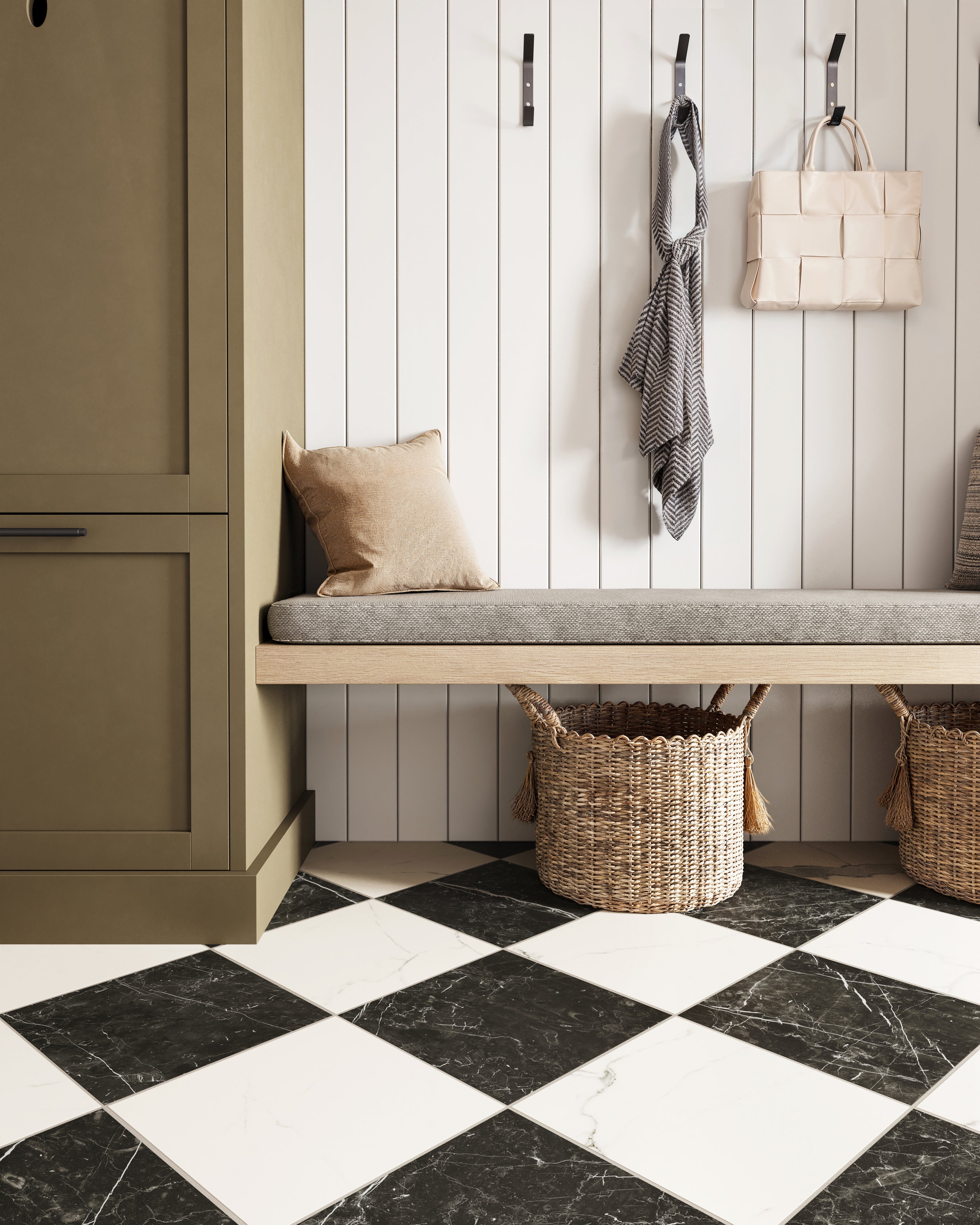 Leona Calacatta and Nero Marquina Checkerboard 12x12 Matte tiles bring bold contrast to this inviting mudroom space.