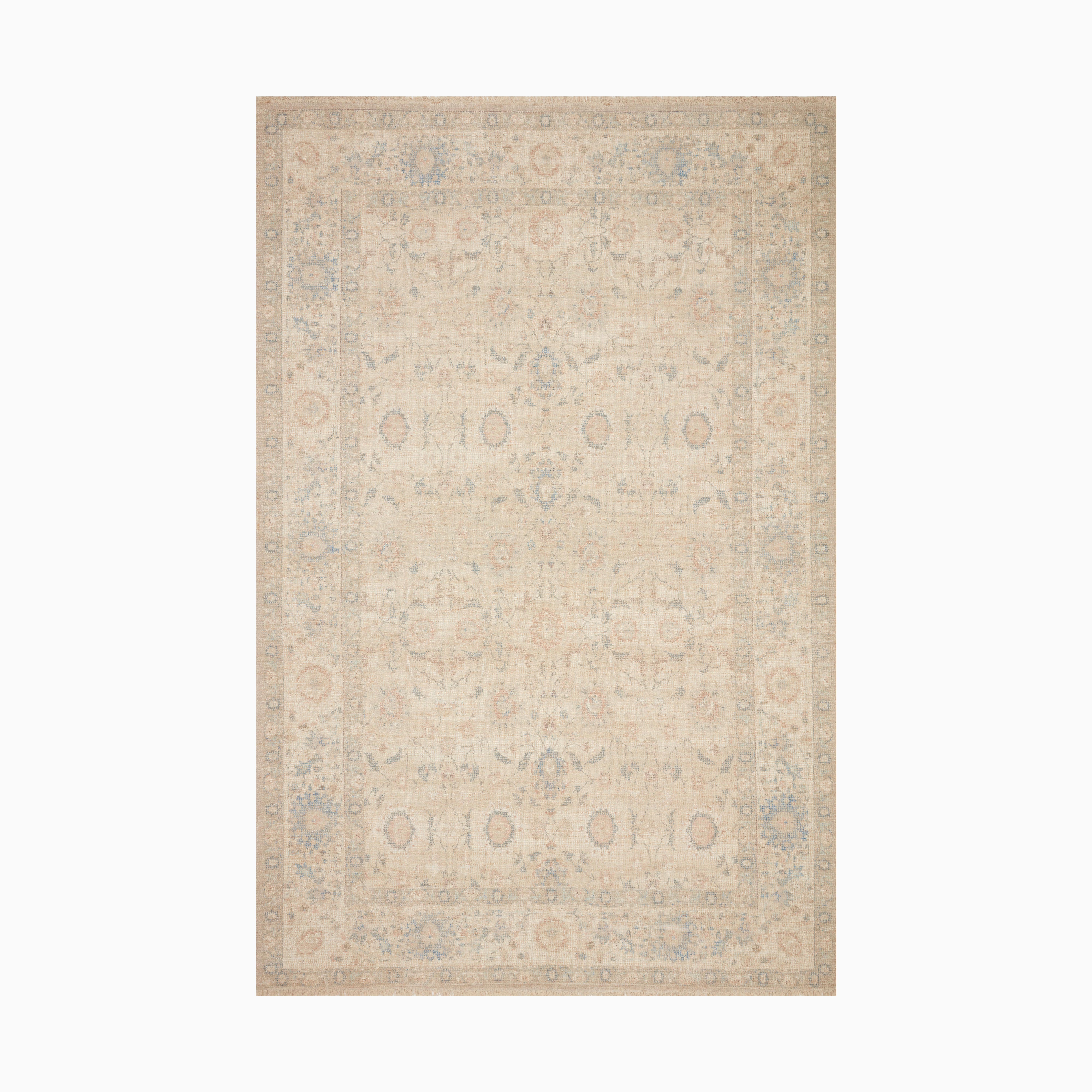 Elegant area rug with a faded floral pattern in soft beige, brick, and lake blue tones, evoking a vintage-inspired charm.